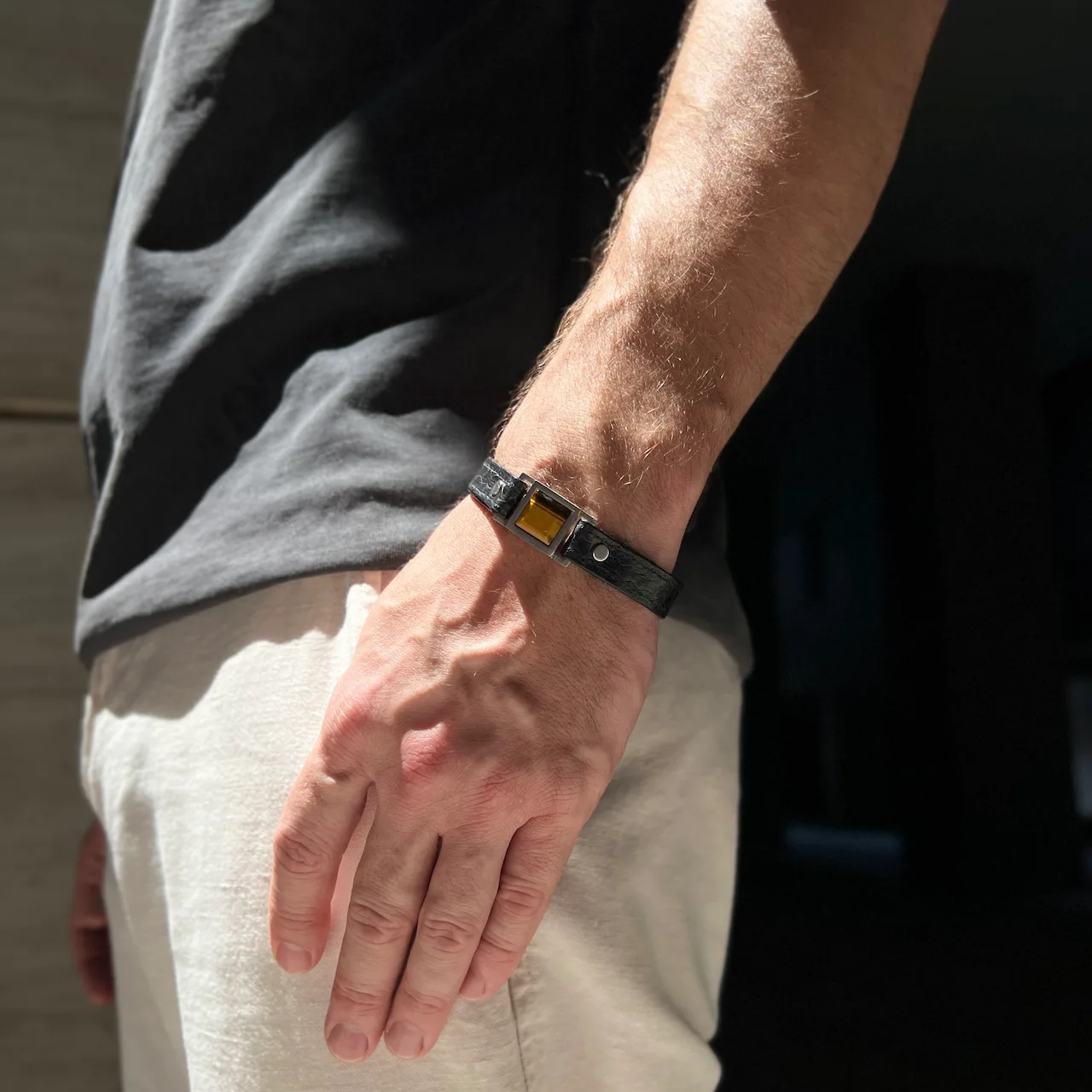 Male model wearing Core bracelet with natural Tiger Eye stone and hidden message by Jewel Cocktail