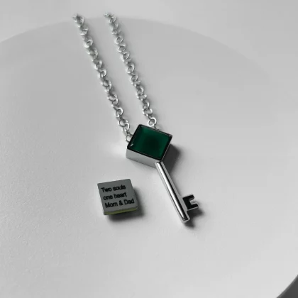 Close-up of Key of Prosperity pendant with natural Green Agate and engraved message – Jewel Cocktail