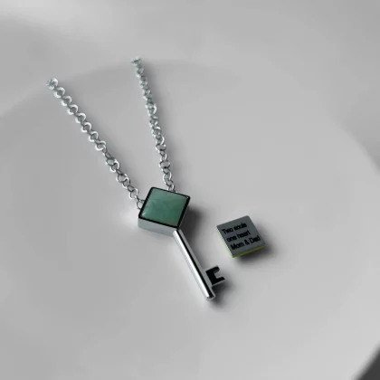 Close-up of custom engraved message on women’s key pendant – Jewel Cocktail